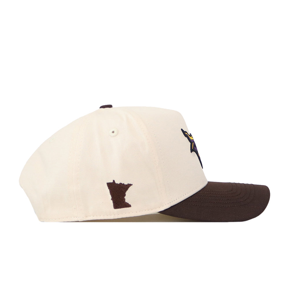 Introducing the Minnesota State University Mankato Espresso Hat by No Rivals—a cream-colored snapback cap featuring a dark brown brim and an embroidered outline of Minnesota in brown on the side. This stylish hat is perfect for finishing off your gameday look.