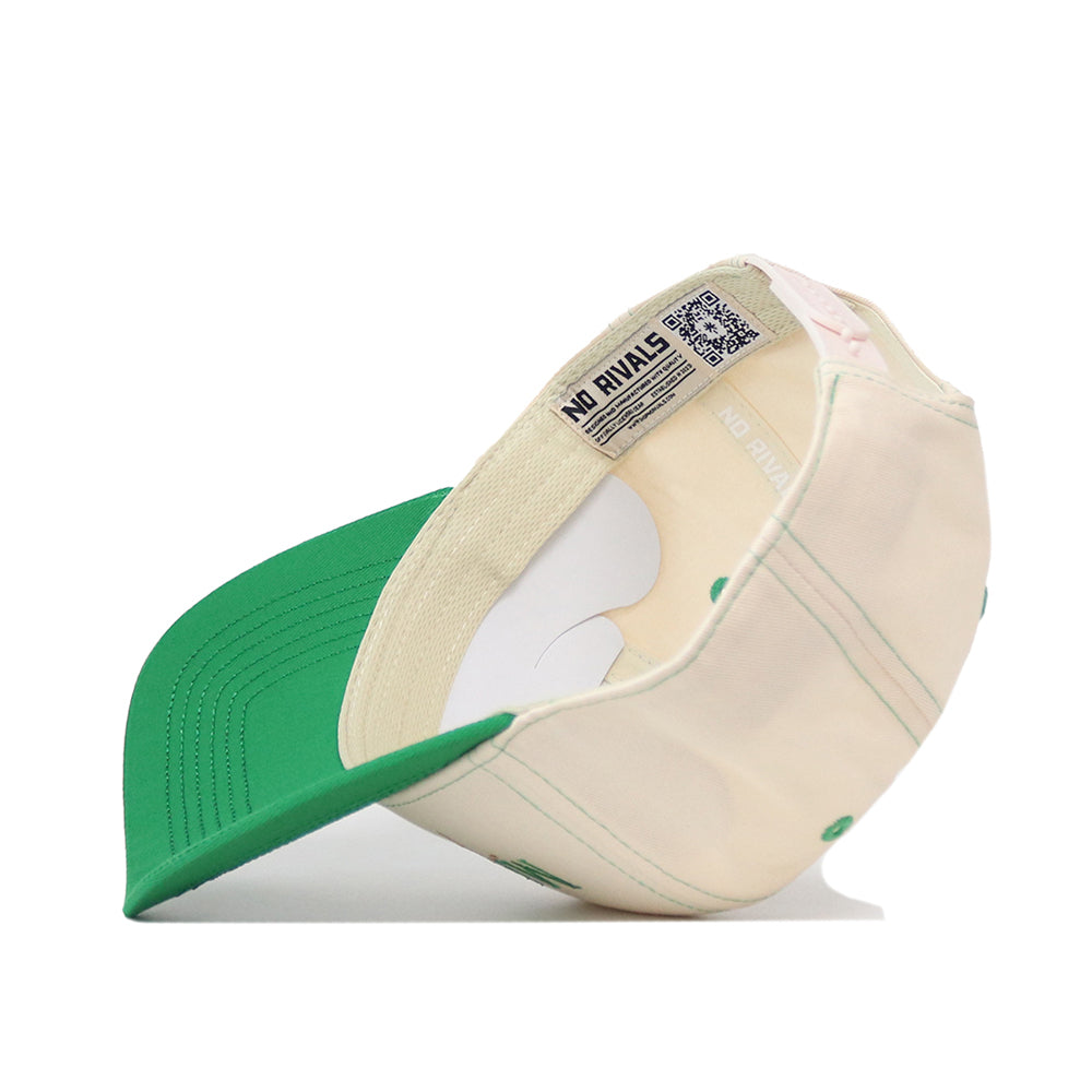 The Marshall Thundering Herd Vintage Hat by No Rivals is shown upside down, highlighting its green bill, cream crown, and interior label featuring the NO RIVALS logo. This cap includes a convenient snap back adjustment for a secure fit—making it the perfect finishing touch for any gameday look.