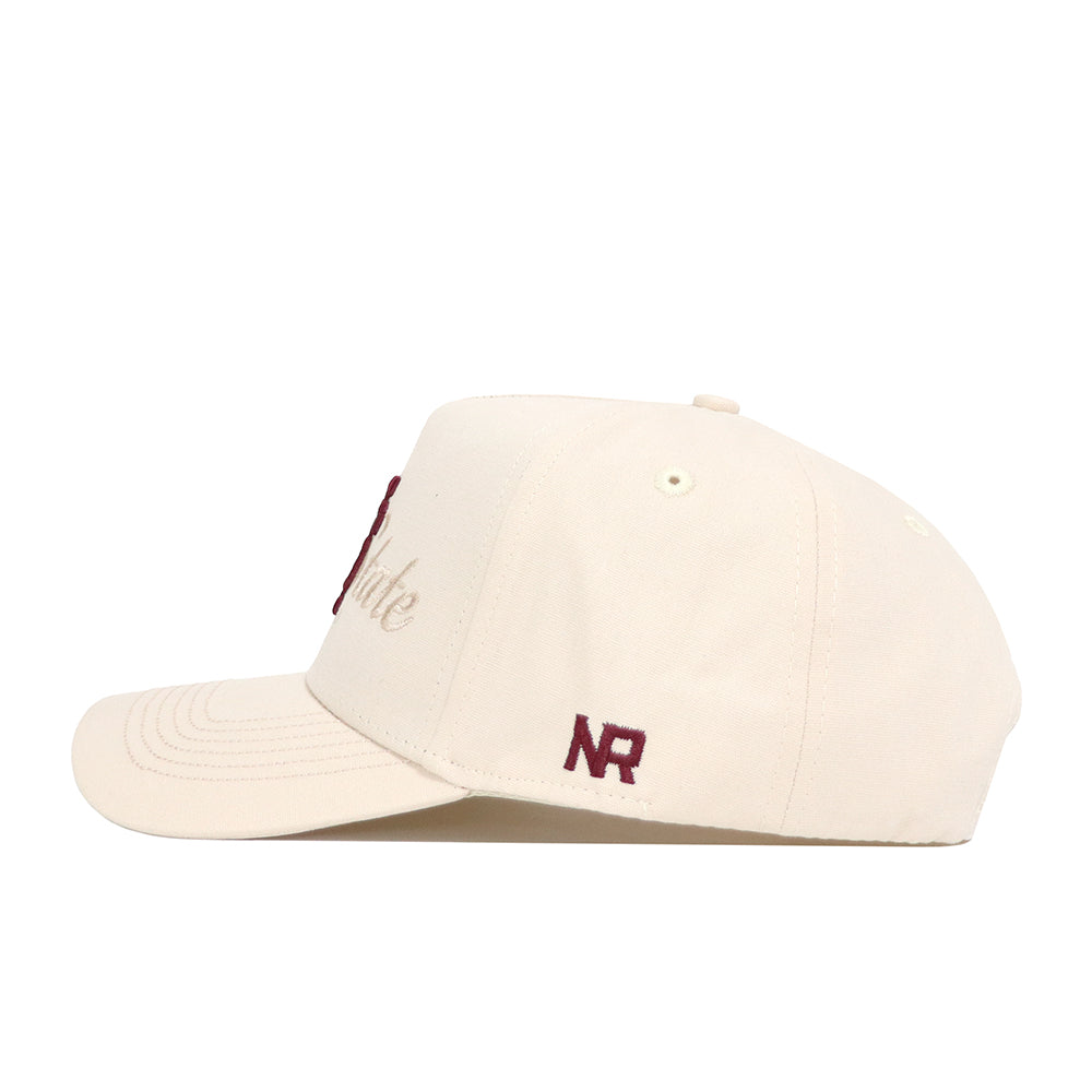 The Mississippi State Stacked Hat by No Rivals is a cream snapback featuring maroon embroidery, NR on the side, partial script on the front, a flat brim, and structured stitching for a premium cotton cap look.