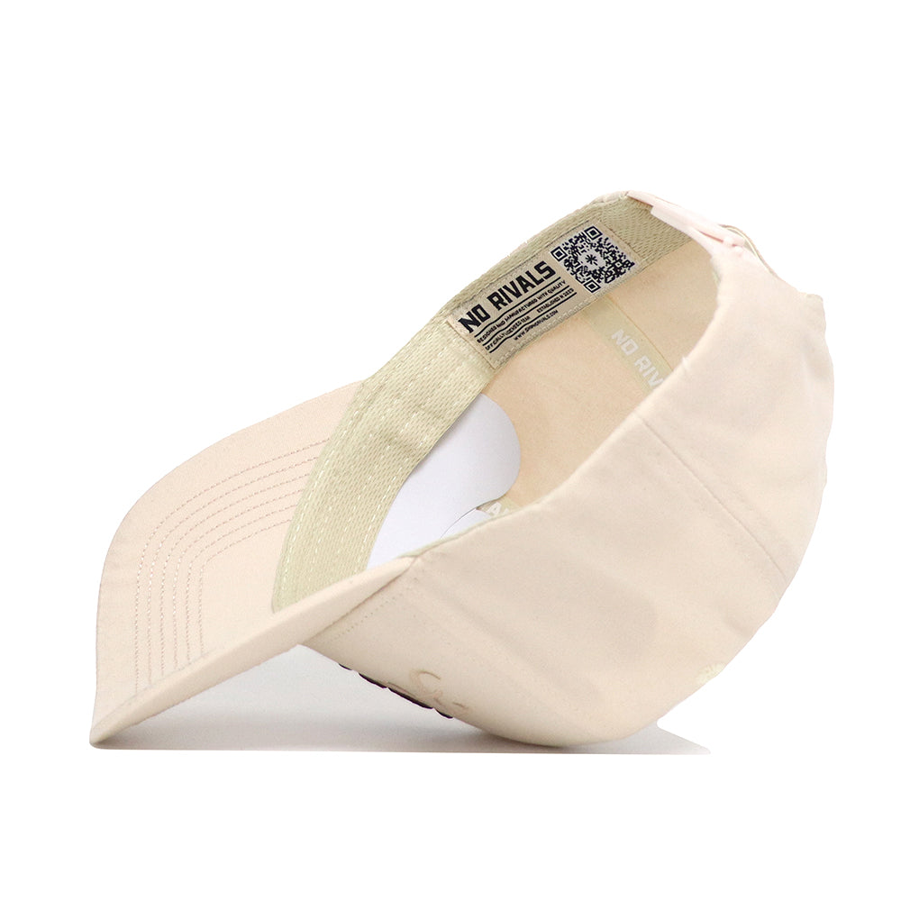 The Mississippi State Stacked Hat by No Rivals is shown upside down, displaying an inside label with NO RIVALS in bold black. This light beige cotton cap has visible stitching and a curved brim.