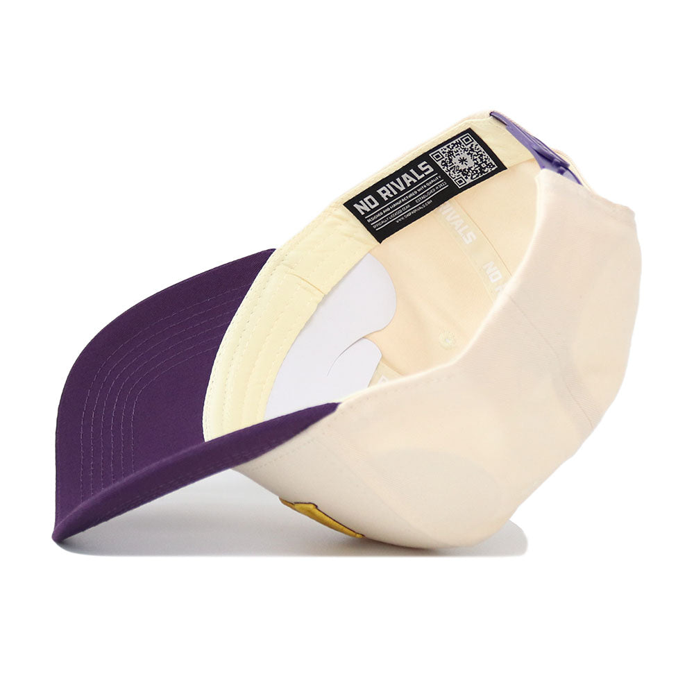 The JMU Vintage Wordmark Hat by No Rivals is shown upside down, displaying its inner NO RIVALS tag and QR code. The unstructured fit delivers comfortable, all-day wear.