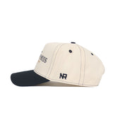 The No Rivals Southern Miss Vintage Hat is a cream snapback with a black curved brim, stitched accents, NR embroidery on the side, and bold partial black text on the front for a sleek, sporty style.