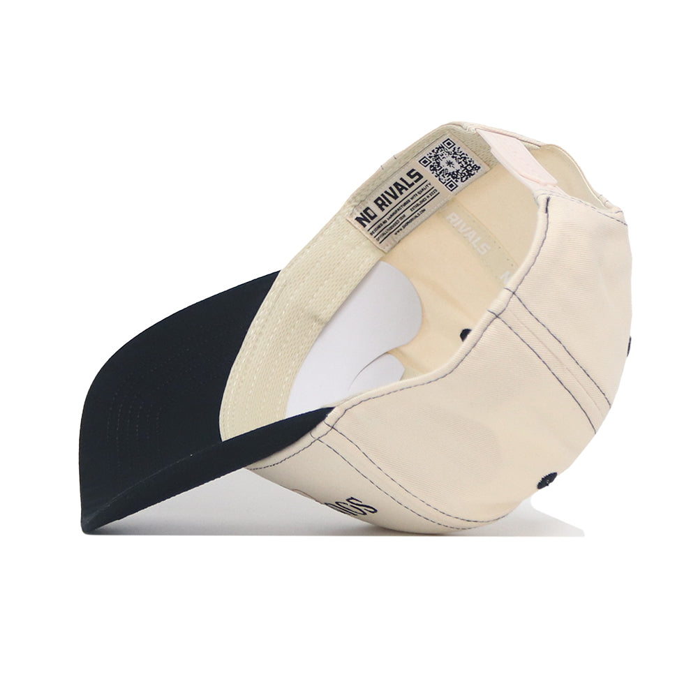 The No Rivals Southern Miss Vintage Hat is a beige snapback with a black curved brim, displayed upside down to highlight the interior tags, stitching, and embroidered logo. It rests on a white surface against a plain background.