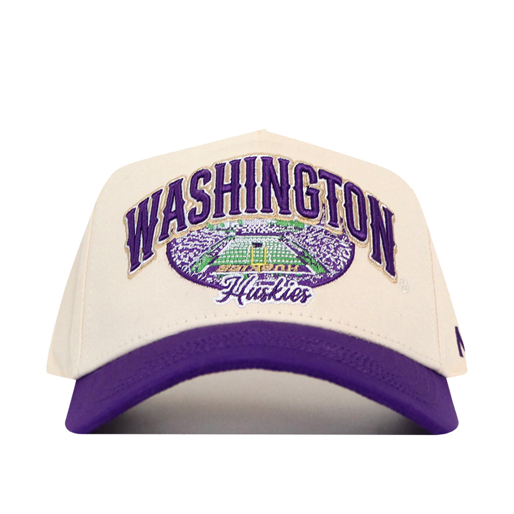 The No Rivals Washington Stadium Hat is a white and purple snapback featuring embroidered, officially licensed Washington Huskies logos and a detailed stadium scene on the front.