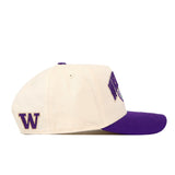 The No Rivals Washington Stadium Hat is an officially licensed cream-colored snapback with a purple brim, showcasing a purple “W” on the side and partial embroidered logos on the front.
