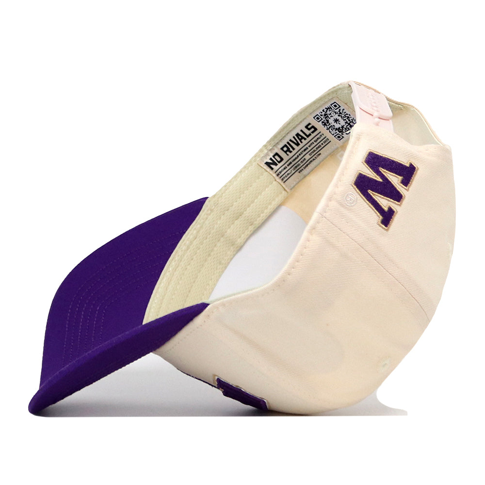 The No Rivals Washington Stadium Hat is a cream and purple snapback baseball cap featuring an embroidered purple W logo on the front. The hat is shown flipped upside down, revealing its inside label and brim. This style is officially licensed.