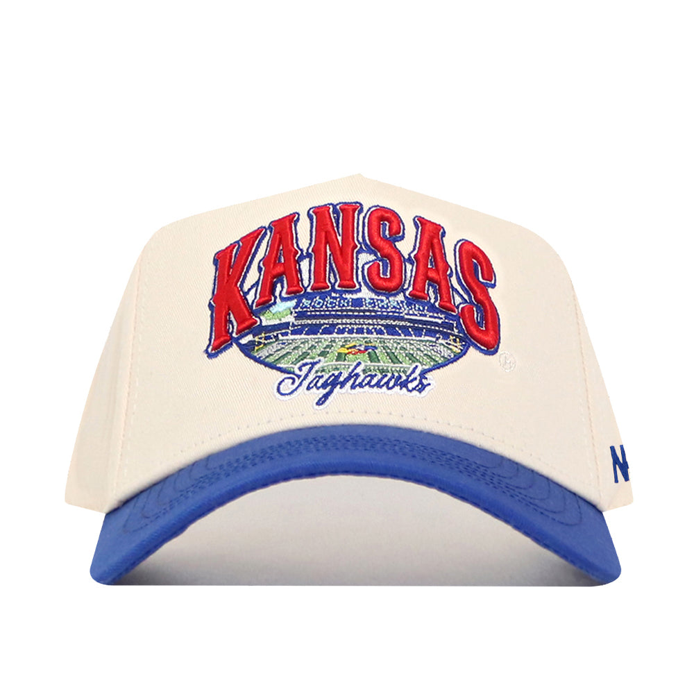 Show your team spirit with the No Rivals Kansas Jayhawks Stadium Hat. This cream and blue baseball cap features "KANSAS Jayhawks" embroidered on the front above a detailed stadium image, along with crisp embroidered logos. An adjustable snap back closure ensures a comfortable fit. Officially licensed, this hat is perfect for any true fan.