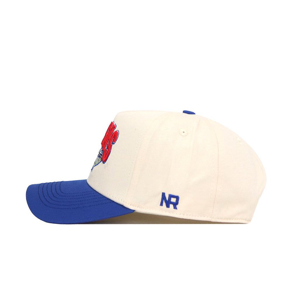 The Kansas Jayhawks Stadium Hat by No Rivals features a cream-colored crown with a blue brim, shown from the side. A small blue NR logo is embroidered near the back, and the snapback closure ensures a comfortable fit.