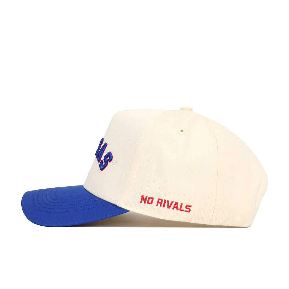 The Right Side Up KANSAS Hat by No Rivals features classic Kansas Jayhawks colors, a cream crown with blue brim, "NO RIVALS" red embroidery on the side, and a high-quality cotton snapback for comfortable, structured everyday wear.