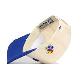 The Right Side Up KANSAS Hat by No Rivals is a cream snapback with blue brim, classic Kansas Jayhawks bird logo on the side, and "NO RIVALS" text plus QR code on the inner band. Made from quality cotton, it's shown positioned on its side.