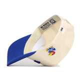 The Upside Down KANSAS Hat by No Rivals features Kansas Jayhawks classic colors in cream and blue, a colorful bird logo, a white tag with blue text, and is crafted from high quality cotton. Inside brim shows printed text and a QR code.