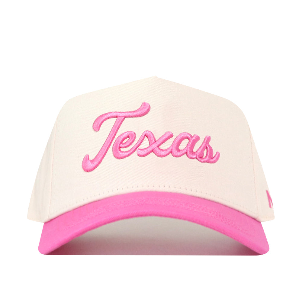 The No Rivals Texas Pink Out Hat is an officially licensed snap back featuring a white crown, a pink brim, and “Texas” embroidered in pink cursive on the front—making it a stylish and spirited breast cancer supporter hat.