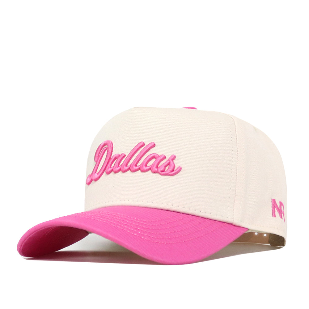 Show your support in style with the officially licensed Dallas Pink Out Hat by No Rivals. This cream-colored baseball cap features “Dallas” embroidered in pink on the front, a vibrant pink brim, and a convenient snap back adjustment for the perfect fit.