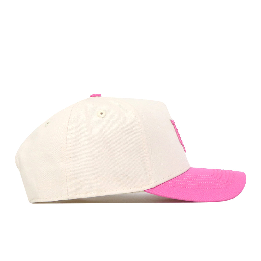 A side view of the cream-colored Utah Pink Out Hat by No Rivals, featuring a pink brim and pink top button, displayed on a white background—perfect as an officially licensed breast cancer hat to show your support with style.