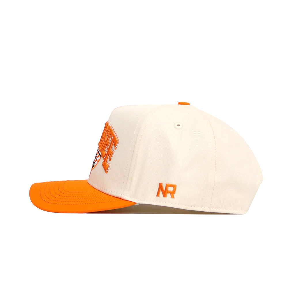 The No Rivals Tennessee Stadium Hat is a white snapback with an orange brim, button, and side "NR" embroidery. Made from high-quality cotton, it has a structured fit and front embroidery that's partially visible from the side.