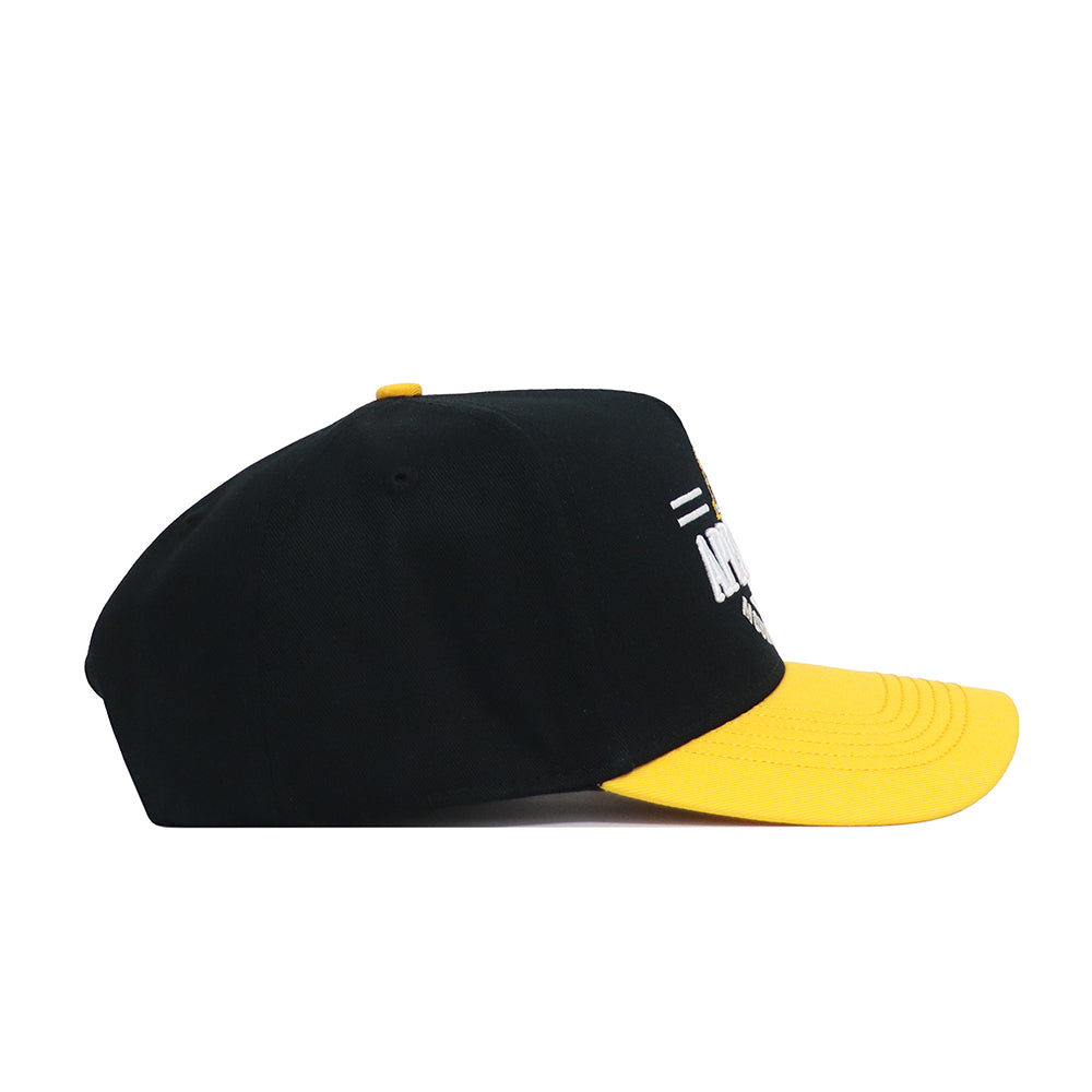 The App State Tailgate Hat by No Rivals features a black snapback design with a bright yellow curved brim, shown from the side on a white background. White and yellow text and graphics are partially visible on the structured, officially licensed cap.