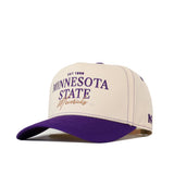 The Minnesota State Mankato Vintage Hat by No Rivals is a beige and purple snapback cap with "EST 1868 MINNESOTA STATE Mavericks" embroidered on the front in purple and gold lettering. This officially licensed hat features a curved brim, visible stitching, and an embroidered logo for a classic look.