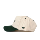 Introducing the Baylor Bears Vintage Hat by No Rivals—a cream-colored snapback baseball cap made from high-quality cotton, featuring a dark green brim and dark stitching. The initials “NR” are embroidered in green on the side, and its one-size-fits-all design ensures comfortable everyday wear.