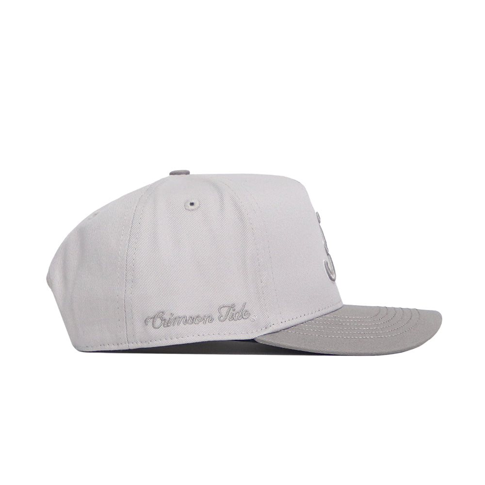 The No Rivals Alabama Graphite Hat features a six-panel light gray structured design, a flat brim, and embroidered Crimson Tide script on the side. The hat is shown from the side to highlight its details.