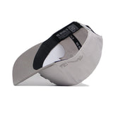 The Alabama Graphite Hat by No Rivals is pictured upside down, revealing its black inner band with "NO RIVALS" and a QR code. Its curved brim and embroidered graphics on top are also visible.