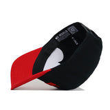 The Western Kentucky Tailgate Hat by No Rivals is shown upside down, revealing its red visor, an inner band with "NO RIVALS" printed in white, and a white heart shape on the interior.