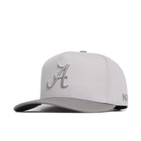 The No Rivals Alabama Graphite Hat is light gray with raised embroidery—a bold 'A' on the front and NFL stitched on the side. Its flat brim and snapback closure give a modern style with an adjustable fit.