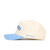 The Upside Down CREIGHTON Hat - Light Blue by No Rivals is a cream cotton-canvas snapback with a light blue brim and "NO RIVALS" embroidered in blue on the side, offering comfort and standout style.