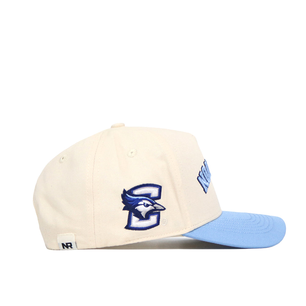 The No Rivals Upside Down CREIGHTON Hat - Light Blue is a cream cotton-canvas hat with a light blue brim, blue jay logo, large C on the side, and an embroidered wordmark—offering structured fit and classic comfort.