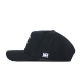 The UCF Outlaw Hat - Black by No Rivals is a black snapback baseball cap shown from the side, featuring a white “NR” embroidered logo on the back. The front displays partially visible small white and yellow designs, making it a perfect addition to your Gameday fit.