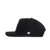 The No Rivals Tennessee Trainer Hat is a black snapback with a flat brim, side view, perforated holes for ventilation, and a small white "NR" PVC patch logo on the side.
