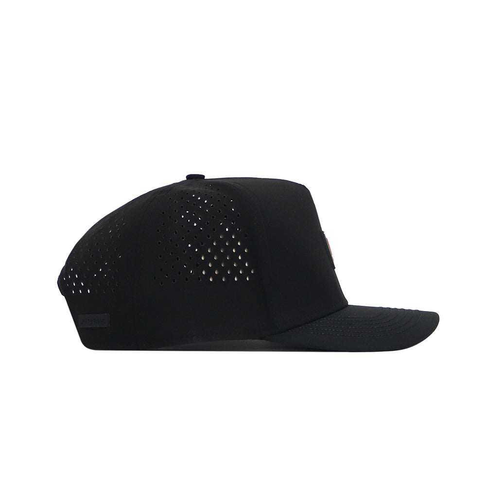 The No Rivals Tennessee Trainer Hat is a black snapback with a flat brim, side ventilation holes, and a sleek PVC patch logo. Crafted from a lightweight performance blend for comfort and style.
