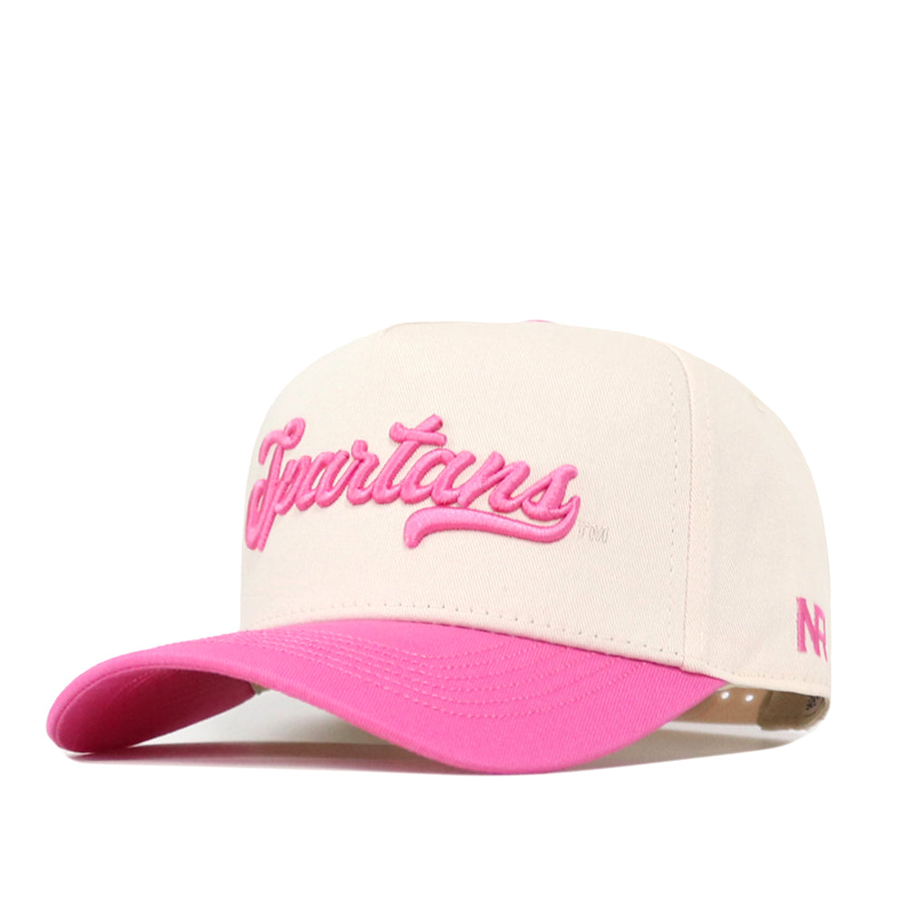 The No Rivals Michigan State Pink Out Hat is an officially licensed beige baseball cap featuring “Spartans” in pink script across the front and a vibrant pink brim. Designed to show support for breast cancer awareness, it also features a small pink logo on the side, combining meaningful purpose with stylish flair.