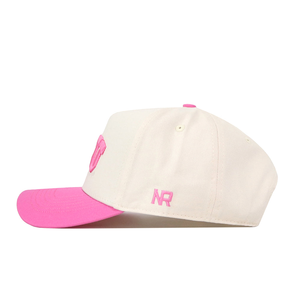 The TCU Pink Out Hat by No Rivals is a white cotton baseball cap with a pink brim, pink NR embroidery, and snap-back adjustment. Shown on its left side.