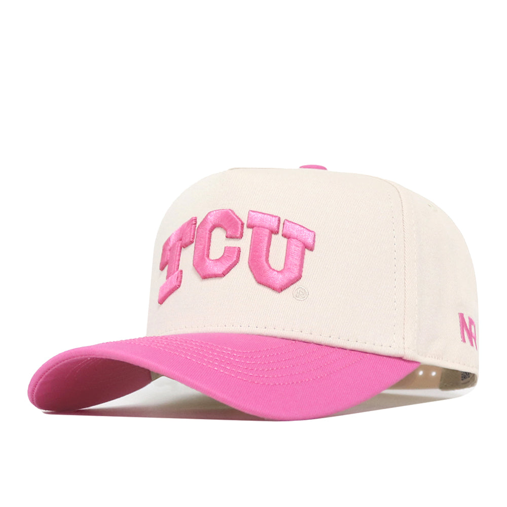 The TCU Pink Out Hat by No Rivals is a beige cotton baseball cap with TCU and N in pink embroidery, a pink brim, snap back adjustment, and shown on a white background.