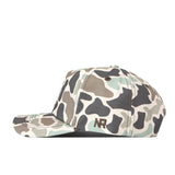 The Auburn Huntsman Hat by No Rivals is a duck camo snapback cap featuring a classic camouflage-patterned baseball style with the letters “NR” embroidered on the side. Shown in side profile against a white background, its 5-panel design enhances both its modern appeal and comfortable fit.