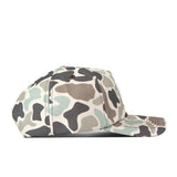 A side view of the No Rivals Auburn Huntsman Hat with a 5-panel design, featuring a camouflage pattern in shades of green, brown, and beige, set against a white background.