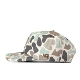 Introducing the Illinois Huntsman Hat by No Rivals—a camouflage-patterned baseball cap in green, brown, and gray hues, shown from the side. This classic snap back style features an embroidered NR logo near the brim and is perfect for elevating your ultimate gameday fit.