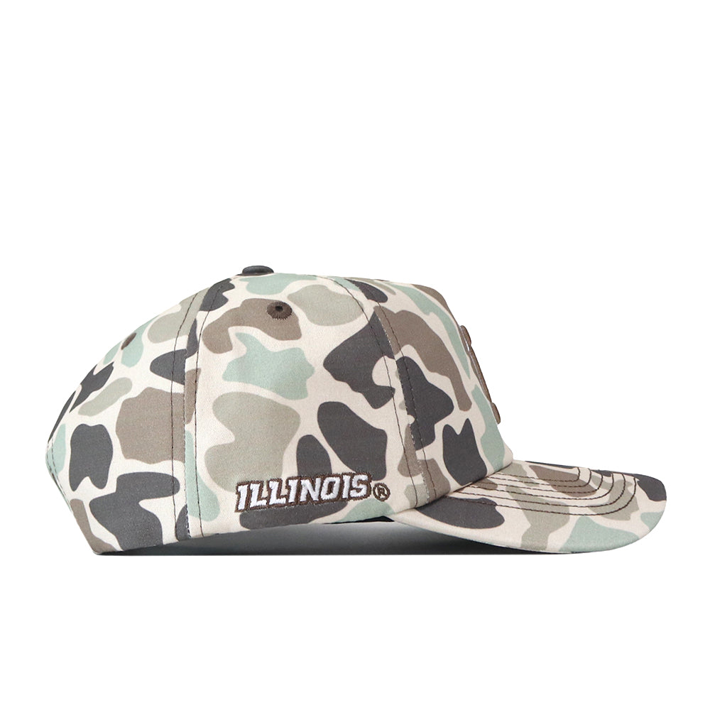 The Illinois Huntsman Hat by No Rivals is a camouflage-pattern baseball cap featuring an embroidered white “ILLINOIS” logo on the side, shown in a side view against a white background—perfect for a classic gameday look.