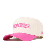 The No Rivals Virginia Tech Pink Out Hat is a white baseball cap with HOKIES embroidered in pink on the front and a vibrant pink curved brim. This officially licensed hat features a small pink N logo on the left side, showing support for breast cancer awareness while celebrating your team spirit.