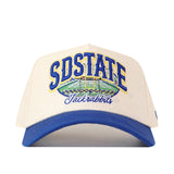 The No Rivals South Dakota State Jackrabbits Stadium Hat is a white snapback with a blue brim, featuring SDSTATE and Jackrabbits embroidered in blue and yellow alongside a detailed stadium illustration on the front—perfect for your gameday look and proudly displaying its bold embroidery.
