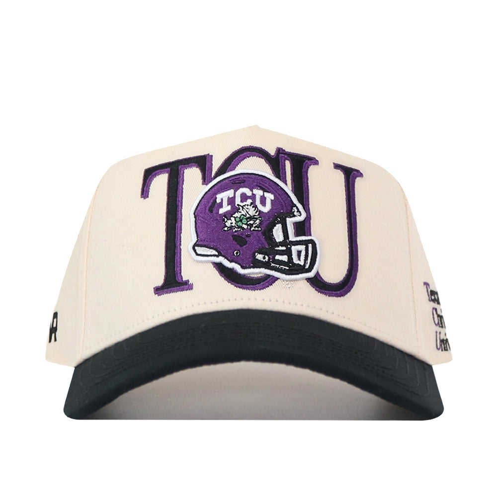 The No Rivals TCU Aer Lingus Football Hat is a cream and black baseball cap featuring bold TCU lettering and a purple football helmet with an embroidered frog logo on the front, plus a snapback closure for the perfect gameday fit.