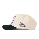 Introducing the TCU Aer Lingus Football Hat by No Rivals—a beige cap with a black brim, highlighted by an embroidered logo and “Texas Christian University” stitched in black and purple on the side. Finished with a snap back closure for an ideal gameday fit.