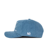 The Ole Miss Vintage Cord Hat by No Rivals is shown from the side in powder blue corduroy, featuring an unstructured fit and white embroidered details, including "NR" initials above the brim.