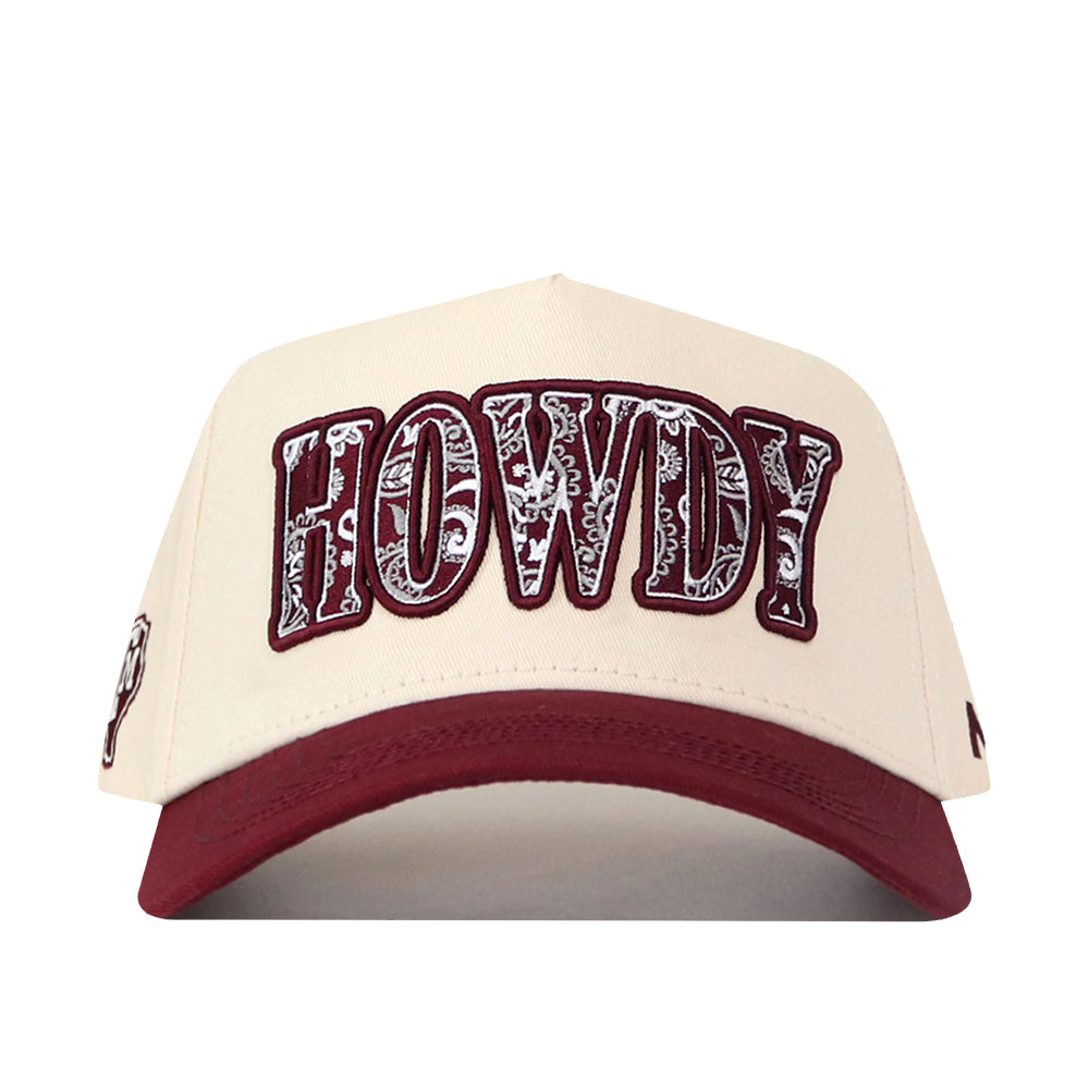 The No Rivals Texas A&M Paisley Howdy Hat is a cream-colored snapback cap with a maroon bill, showcasing “HOWDY” in bold, patterned maroon and white letters on the front. This officially licensed hat features an embroidered logo for a stylish and authentic finish.
