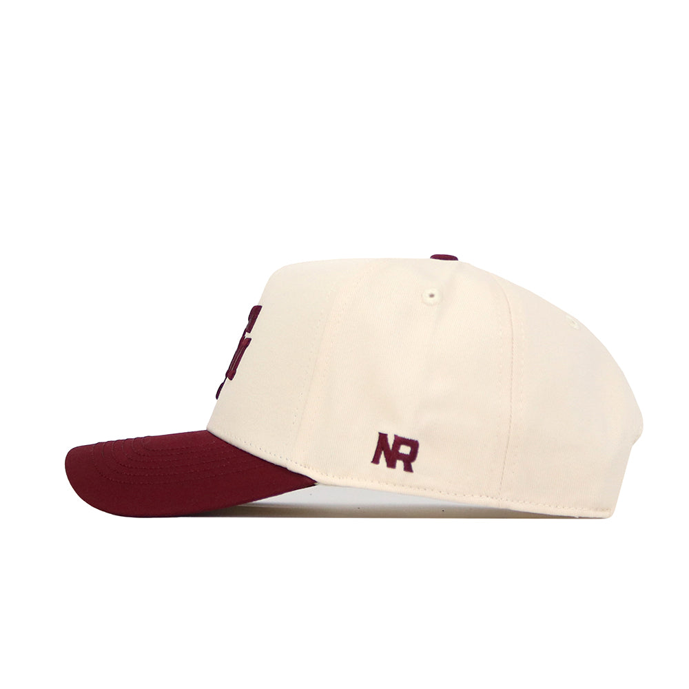 The No Rivals Texas A&M Logo Patch Hat features a cream snapback design with a maroon brim and 3D maroon "NR" embroidery on the side, crafted from high quality cotton.