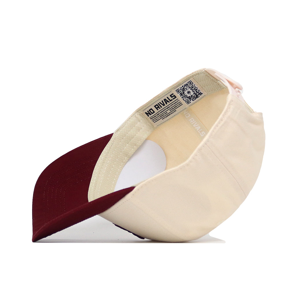 The Texas A&M Logo Patch Hat by No Rivals is beige with a maroon brim and features 3D embroidery and an official label with NO RIVALS text and QR code visible inside.