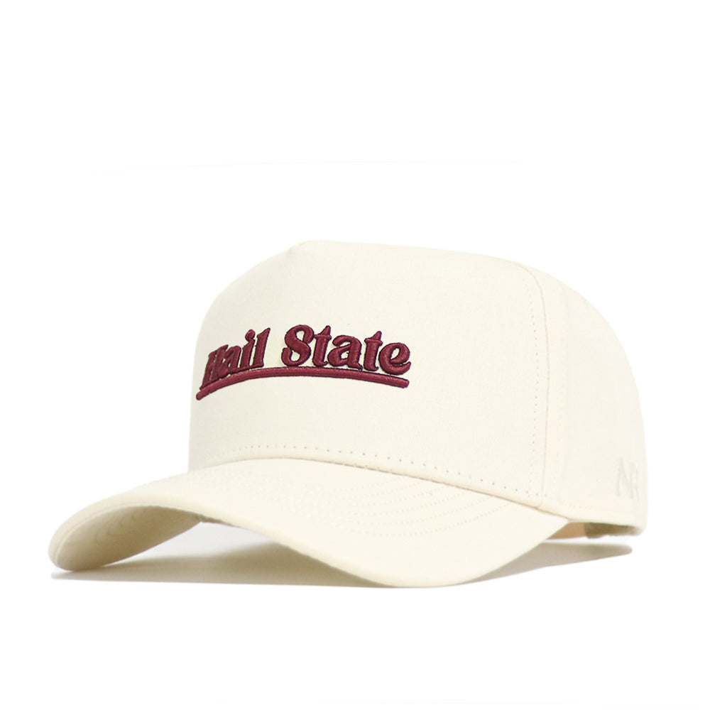 The Mississippi State Sideline Hat by No Rivals is a cream snapback with "Hail State" embroidered in maroon, featuring high-quality cotton, a curved brim, structured fit, and front panels.
