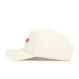 The Clemson Sideline Hat by No Rivals is a cream cotton baseball cap, shown from the side, featuring an orange embroidered front logo and white NR letters on the side above the adjustable strap.