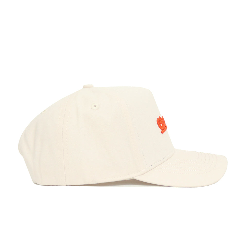 The Clemson Sideline Hat by No Rivals is a beige cotton baseball cap with a curved brim, structured fit, and small orange embroidered logo on the front, shown from the side against a plain white background.