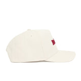 The Indiana Sideline Hat by No Rivals is a white snapback with a curved brim, structured fit, and a small red embroidered front design, crafted from high-quality cotton and shown in side view.